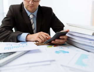 Accountant working on stack of papers