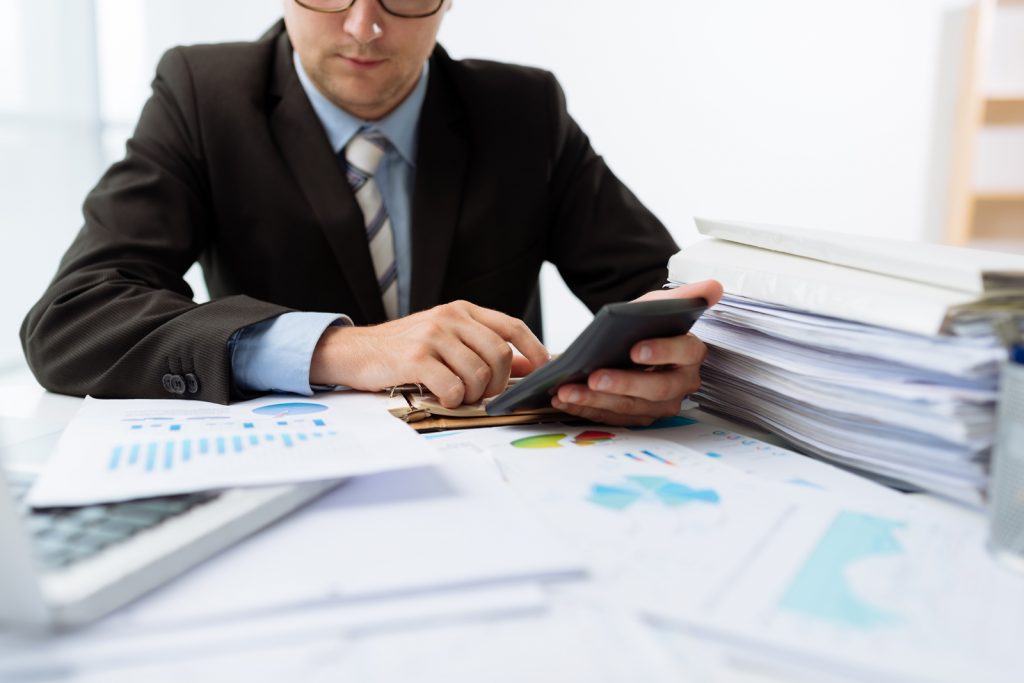 Accountant working on stack of papers
